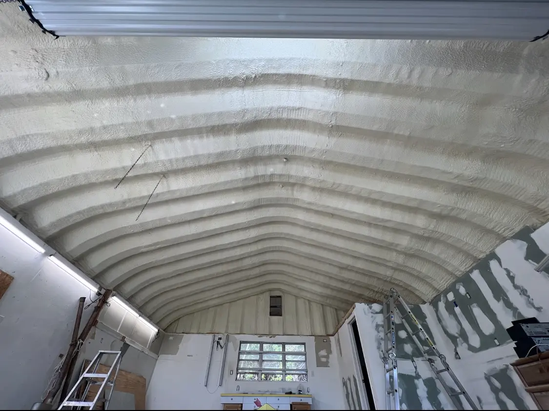 Spray polyurethane foam applied to the underside of a metal roof deck in Fort Lewis